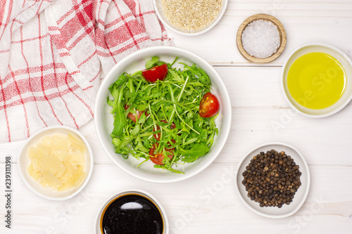 Wallpaper Mural Mixed arugula leaves and sliced cherry tomatoes. recipe step by step arugula salad in a grey ceramic bowl flatlay on white wood Torontodigital.ca