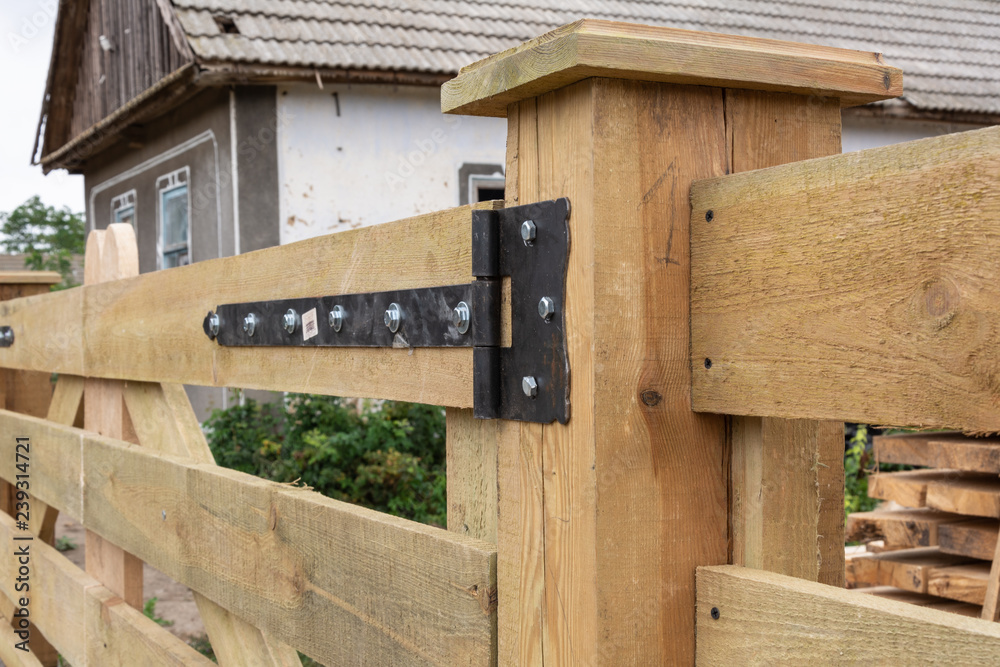 Fototapeta premium Forged hinges. Forged hinges on the fence ranch style.
