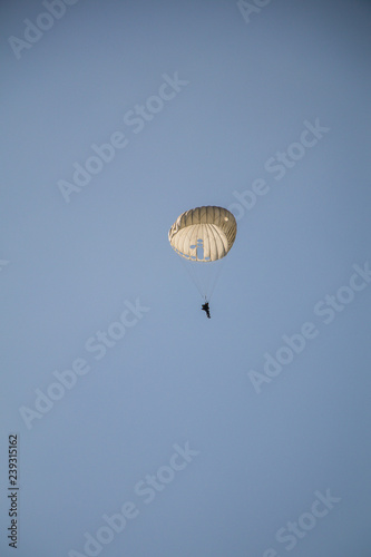 Jump of paratrooper with white parachute, Military parachute jumper in the sky.