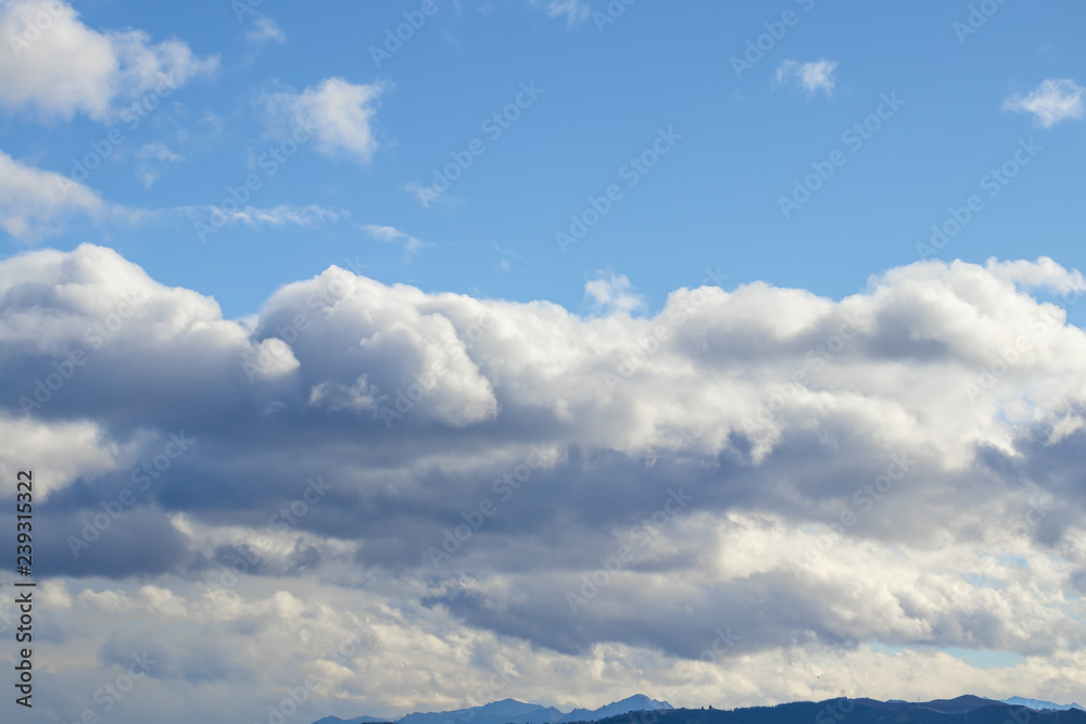 Mountain range in clear weather in contrasting rain clouds before the rain