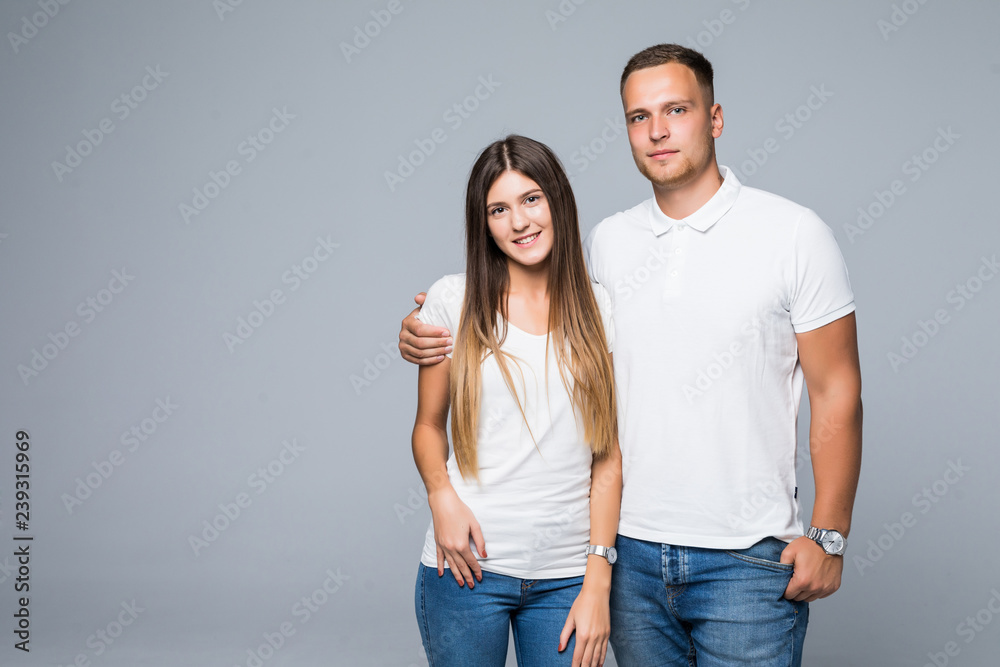 Portrait of happy couple looking at camera on gray background Portrait of happy couple looking at camera on gray background