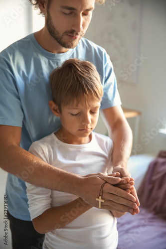 Father with son praying at ...