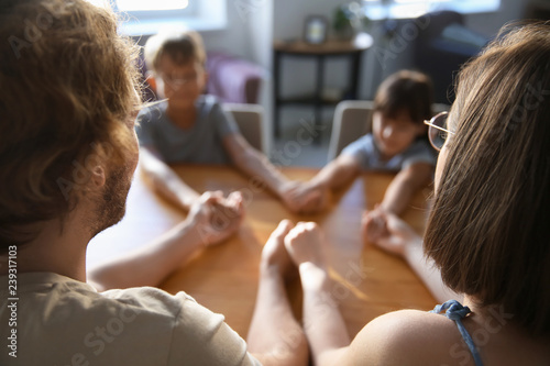 Family praying at home