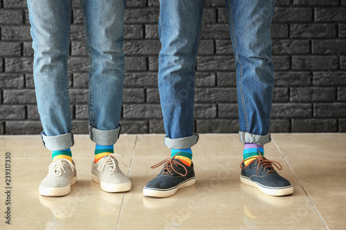 Gay couple with colorful socks indoors