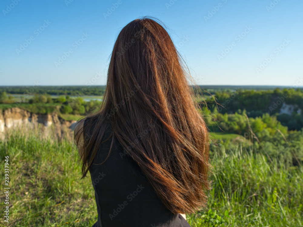 Relaxed young woman looking out into the view. Relaxed young woman looking out into the view.
