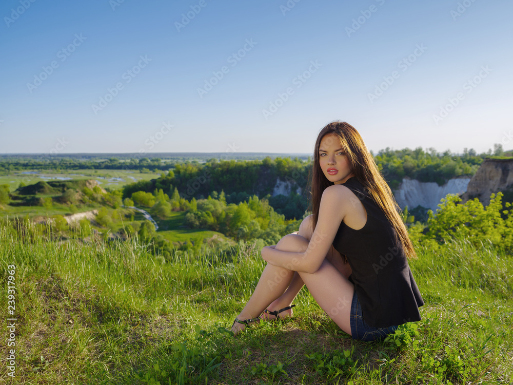 Attractive girl with long hair relaxes outdoor. Attractive girl with long hair relaxes outdoor.