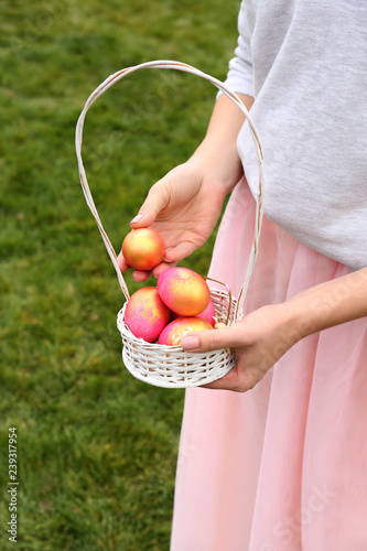 Woman holding wicker basket...