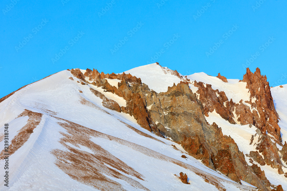 Strict and majestic peaks of Mount Erciyes on a clear sunny day in central Turkey.