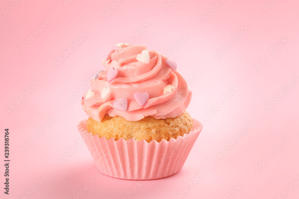 Tasty cupcake on color background