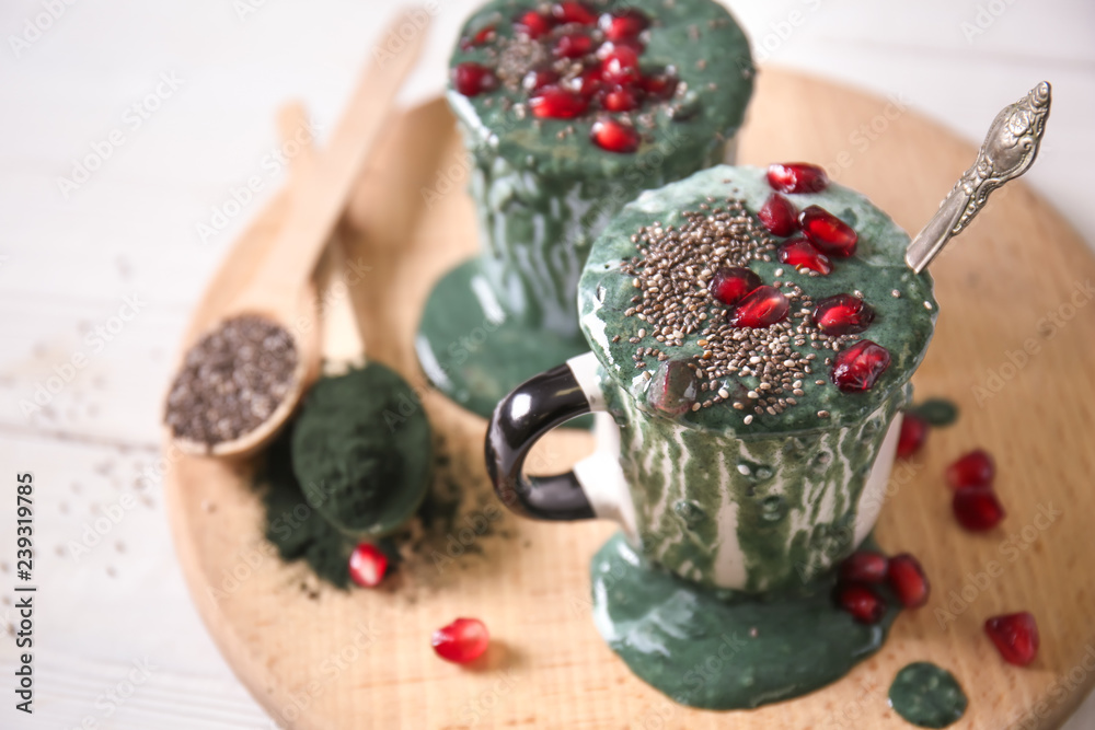 Cups of spirulina smoothie on table Cups of spirulina smoothie on table