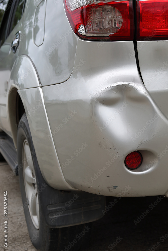 vehicle car bumper dent and taillight broken collision crash damage accident on road