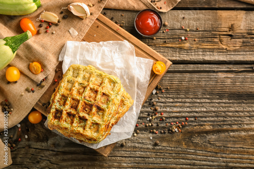 Stack of tasty squash waffles on wooden table