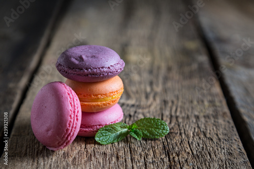 Colorful macaroons on wooden table photo