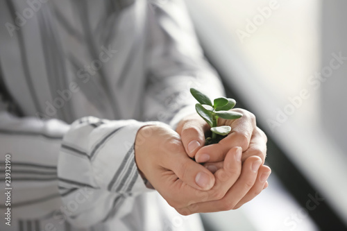 Businesswoman holding green...