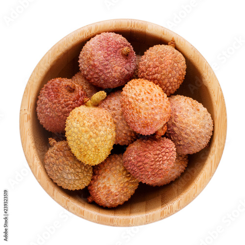 Fresh lychee in wooden bowl isolated on white background. Top view.