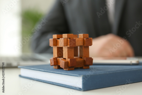 Brain teaser on table of businessman