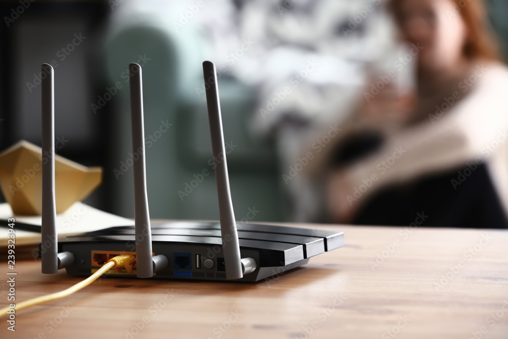 Ταπετσαρία Modern wi-fi router on wooden table in room