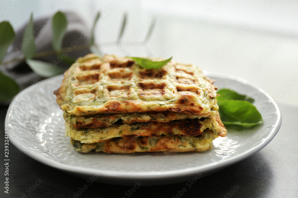 Plate with tasty squash waffles on grey table