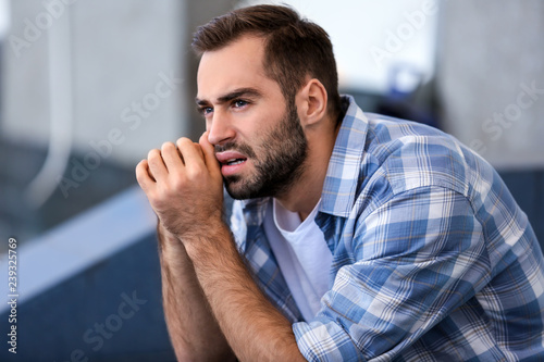Portrait of stressed young man outdoors