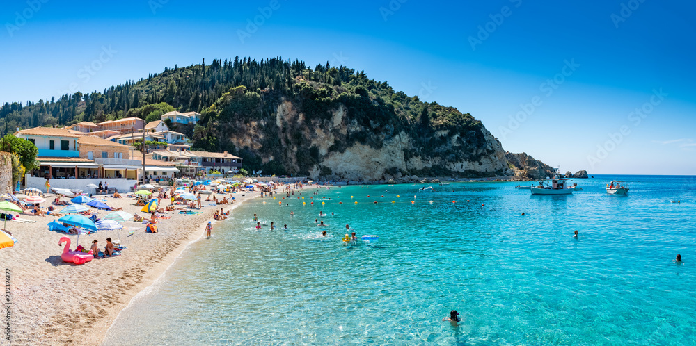 People in summer holiday on the seaside of Agios Nikitas beach, in Lefkada island of Greece - Europe