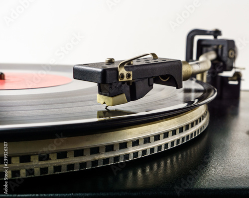 Retro turntable vinyl record player. Vintage record player. Old analog audio equipment for sound enthusiast and professional disc jockey photo