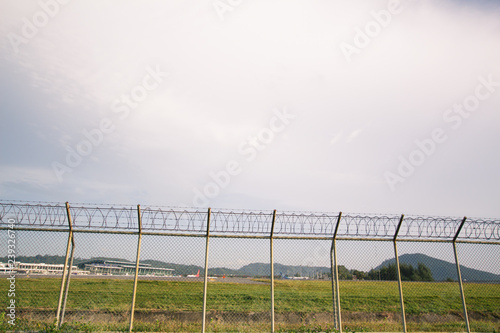 Metal fence wire, War and sky in the background in Phuket Thailand