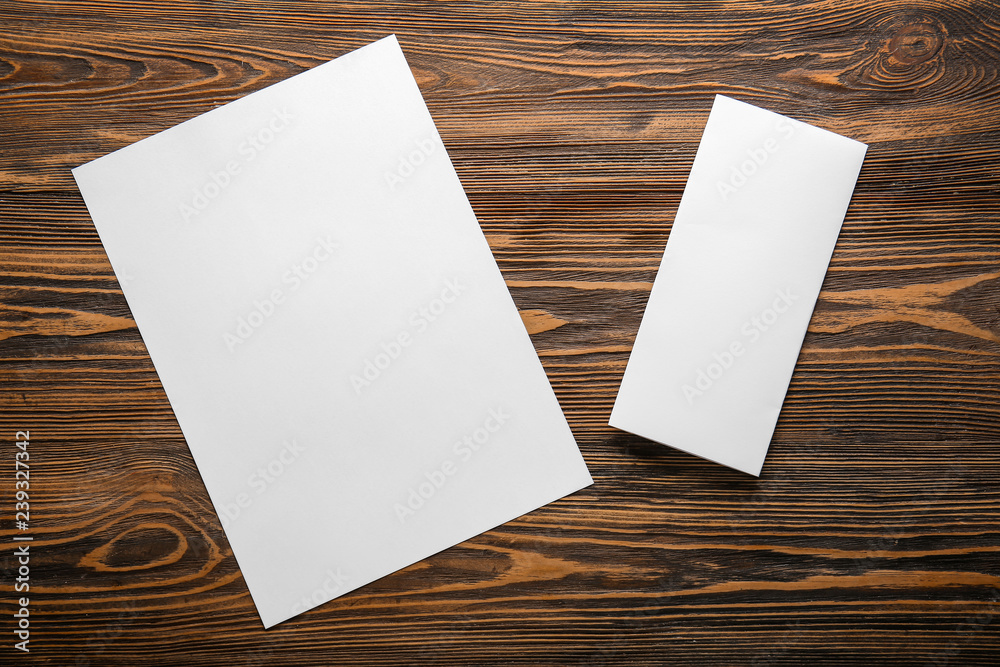 Empty sheets of paper on wooden table Empty sheets of paper on wooden table