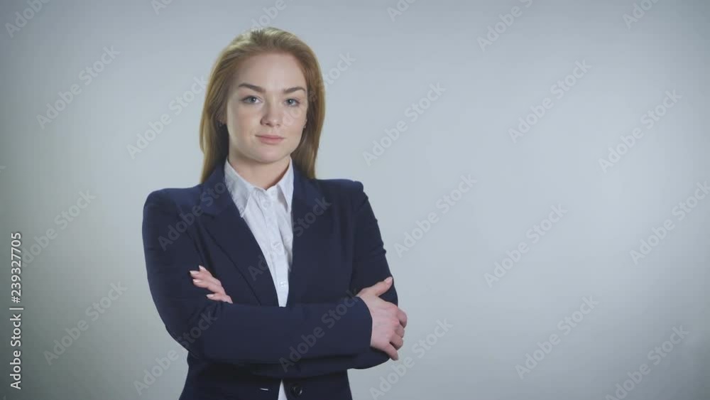 Young woman confidently looks into the camera on a white background Young woman confidently looks into the camera on a white background