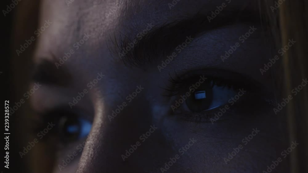 Young woman looks into the computer monitor close-up of the eye Young woman looks into the computer monitor close-up of the eye