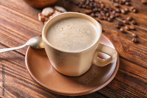 Fototapeta Naklejka Na Ścianę i Meble -  Cup of tasty aromatic coffee on wooden table