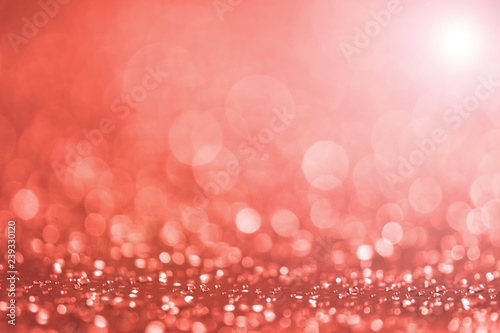 Beautiful sparkling background made of Living Coral color. Shiny bokeh background for holidays, Valentine's Day, Christmas.