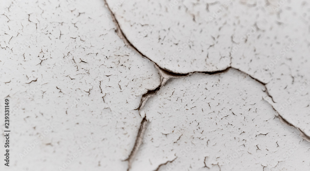 Fototapeta premium Old white cracked plaster wall surface for background or texture
