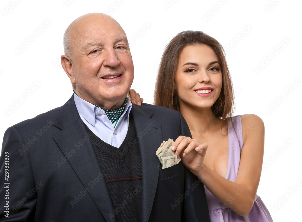Young woman taking money from senior man's pocket on white background. Marriage of convenience Young woman taking money from senior man's pocket on white background. Marriage of convenience
