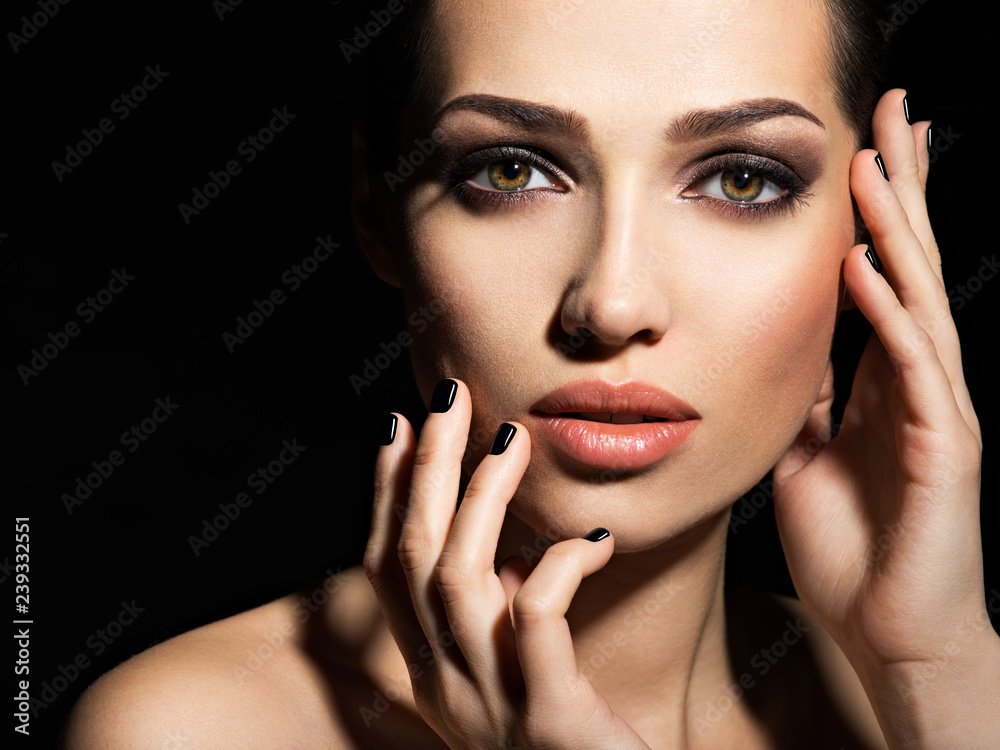 Face of a beautiful girl with fashion makeup and black nails Face of a beautiful girl with fashion makeup and black nails