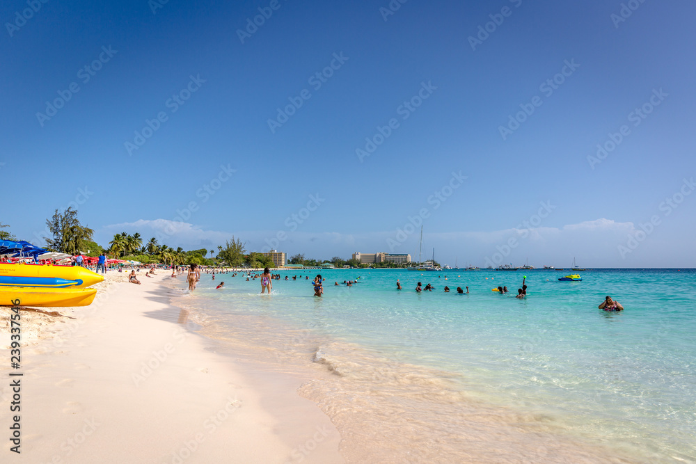 Dover Beach, Barbados - Mar 5th 2018 - Tourists and locals having fun at the Dover Beach in Barbados in a clear sky day