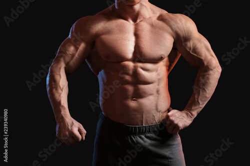 Muscular bodybuilder on dark background © Pixel-Shot