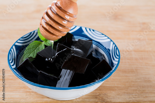 Guilinggao with honey, a traditional Chinese Herb-Made Dessert. photo