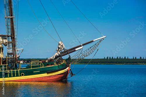 large sailing wooden ship sails through beautiful blue water..