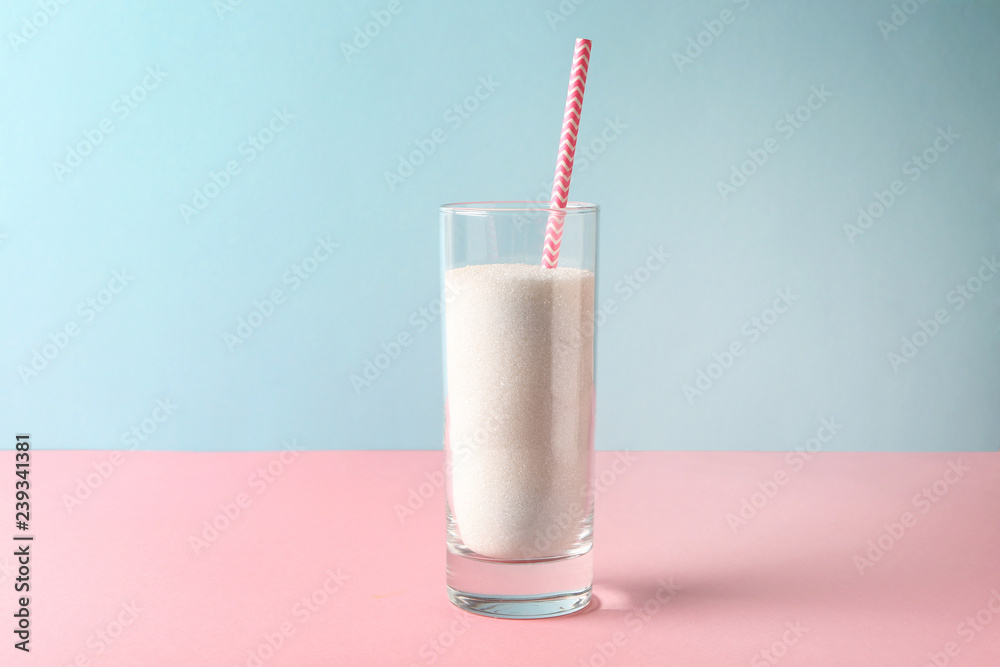 Glass with sugar on table. Diabetes concept Glass with sugar on table. Diabetes concept