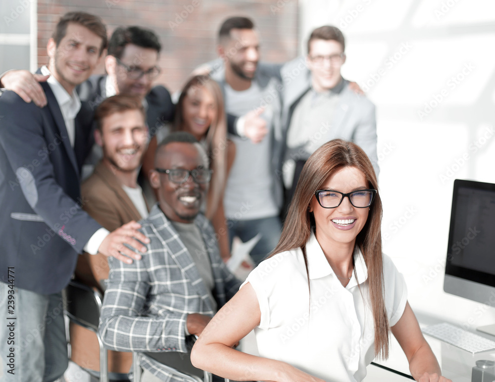 group of young employees near the desktop group of young employees near the desktop