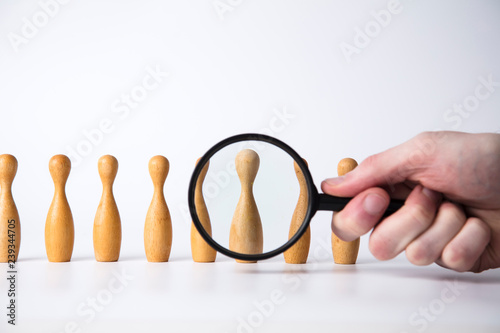 Recruitment concept. Magnifying glass with wooden people. Talent, Job, Opportunity concept