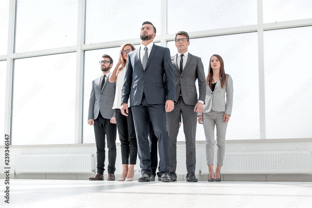 businessman and his business team standing in a spacious office businessman and his business team standing in a spacious office