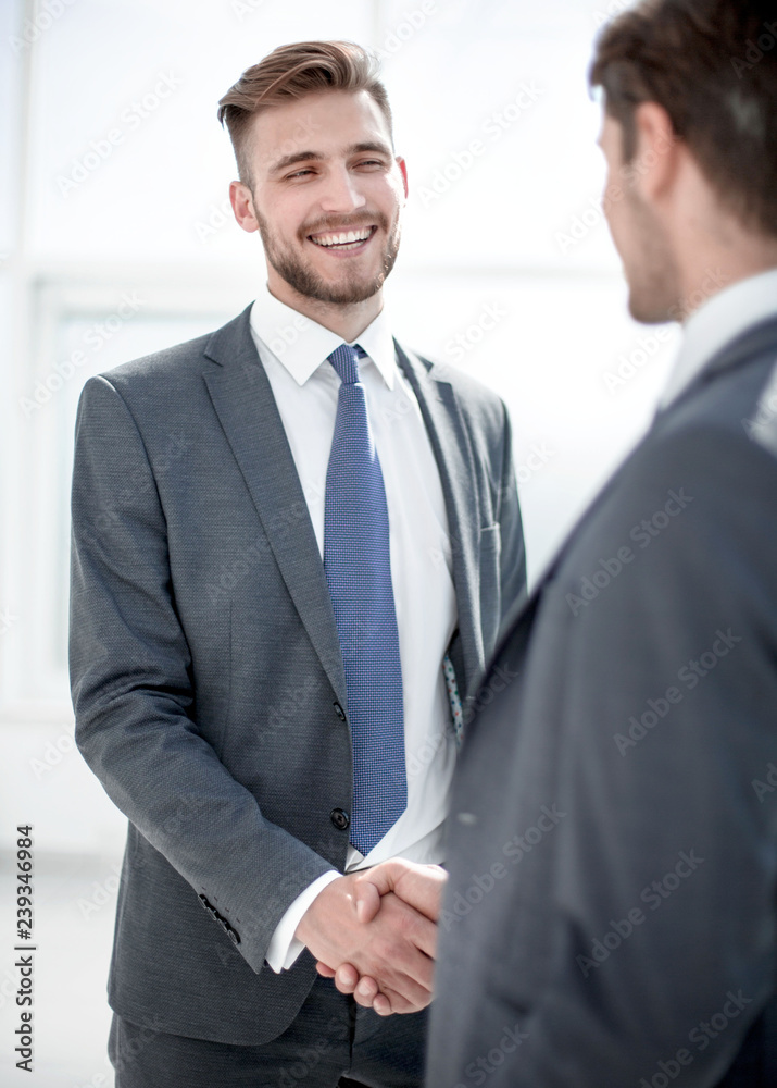 Fototapeta premium smiling business partners shaking hands.