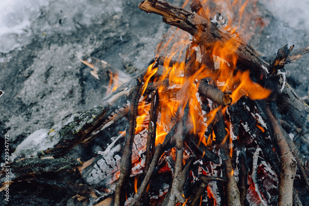 Camp fire in the snow . Concept adventure active vacations outdoor. Winter camping Camp fire in the snow . Concept adventure active vacations outdoor. Winter camping