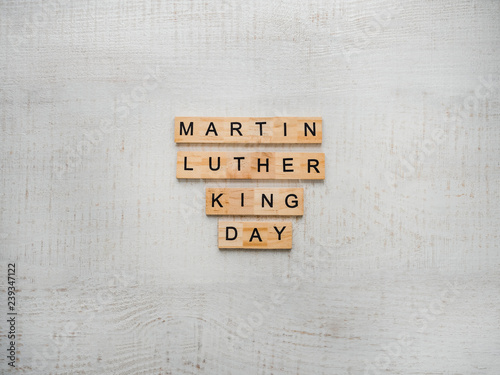 Martin Luther King, Jr. Day. Beautiful greeting card. White isolated background, close-up, top view, wooden surface. Congratulations for loved ones, relatives, friends and colleagues