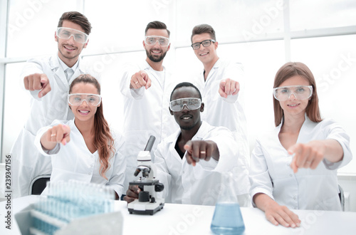 Group of young successful scientists posing for camera