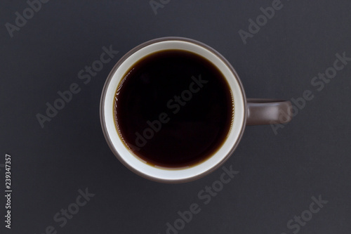 Cup of coffee on the gray background. Top view, flat lay, copy space, card layout