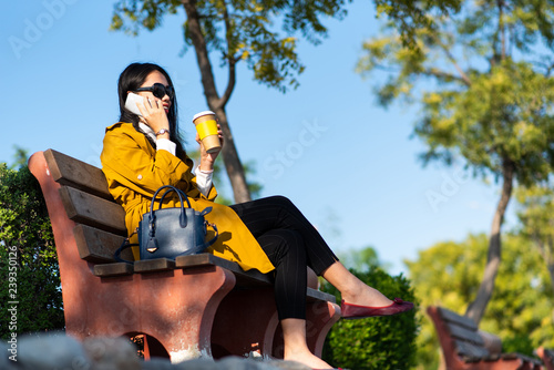 Girl enjoying a cup of coffee and using phone