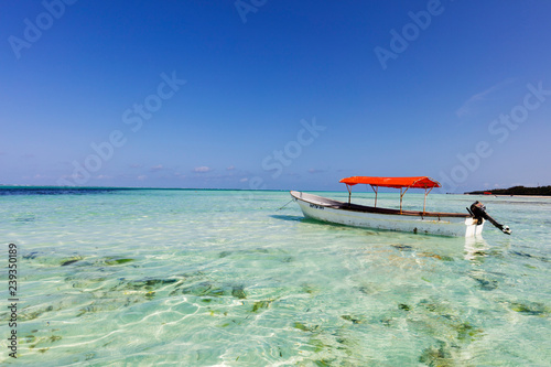 East Africa, Tanzania, Zanzibar island, Pingwe, small boat in crystal clear water photo