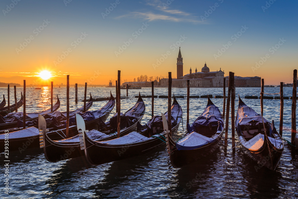Venetian winter sunrise after snow; gondolas, San Giorgio Maggiore and Lido; Venice, UNESCO World Heritage Site, Veneto, Italy Venetian winter sunrise after snow; gondolas, San Giorgio Maggiore and Lido; Venice, UNESCO World Heritage Site, Veneto, Italy